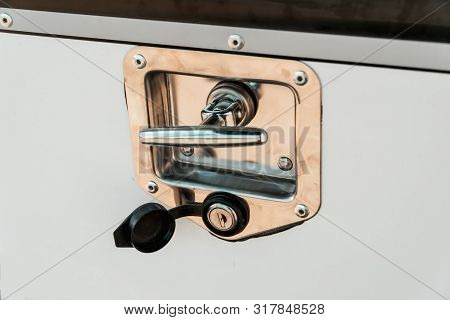 Photograph Of A Metal Lock On A White Door