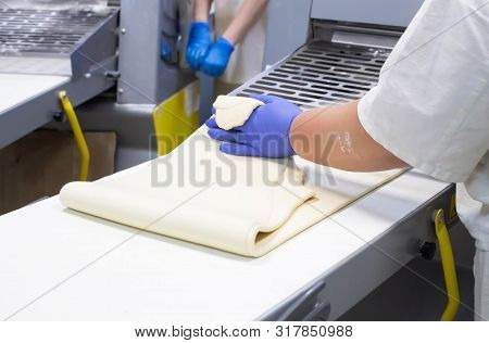 Chef Condite Rolls Puff Pastry On A Dough Sheeter For Pizza Making, Rolling Dough