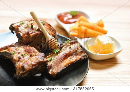 Bbq Pork Ribs Grilled With Honey Sweet Sauce And Herbs Spices Served On The Table / Roasted Barbecue