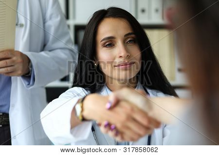 Beautiful Smiling Female Gp Shaking Hands With Visitor Portrait. Self Introduction Cheering And Supp