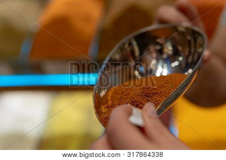 Scooping Brown Spices At Market