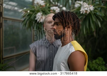 Bearded Dark-skinned Man With Dreads Standing Near Blonde Man