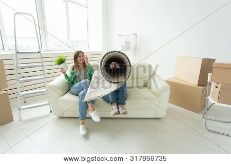 Relocation, Real Estate And Moving Concept - Young Funny Cheerful Couple Moving Into Their New Home