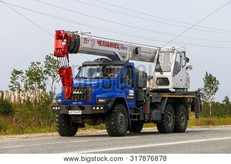 Novyy Urengoy, Russia - July 30, 2019: Modern Construction Crane Ural 4320 Next At The Interurban Ro