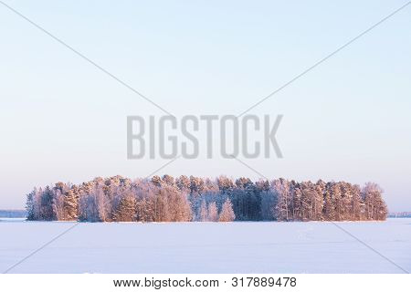 Winter Forest Island At Forzen Lake Sunset Landscape
