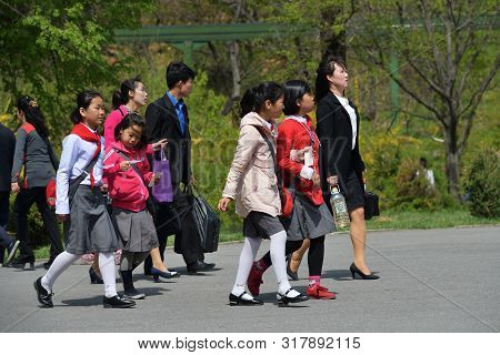Pyongyang, North Korea - May 1, 2019: Parents With Children Go To The Taesongsan Funfair. Is An Amus
