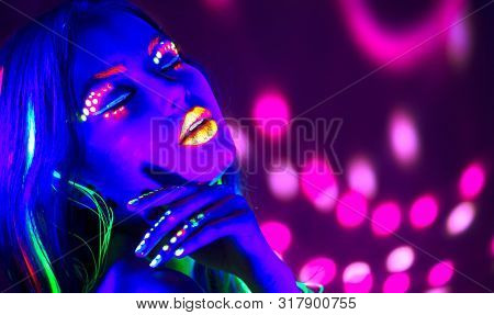 Neon Woman dancing. Fashion model woman in neon light, portrait of beautiful model with fluorescent make-up, Art design of female disco dancer posing in UV, colorful make up. On bright background