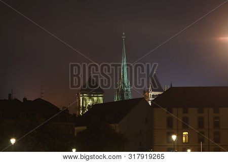 St. Pierre Cathedral (st. Peter's Cathedral) Spire Highlighted Above Geneva City At Night, Geneva, S