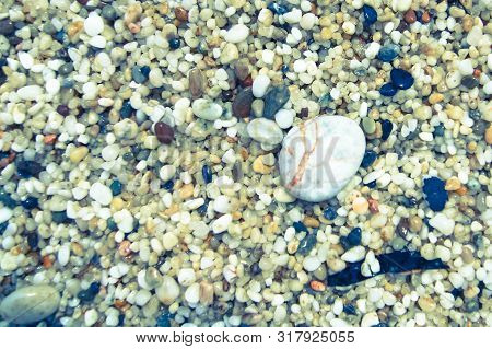 Macro Close Up Of Coarse Rice-sized Multi-coloured Wet Shiny Sand Grains And Gravel Texture, Top Vie