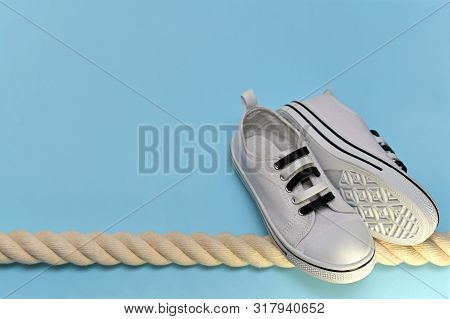Sports Shoes, Folded Pair Of Soles To The Soles On The Side On The Right Side Of The Rope.