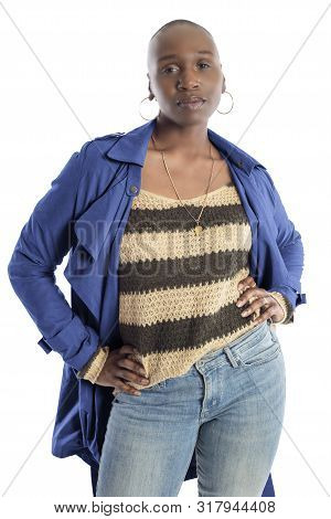 Black African American Fashion Model With Bald Hairstyle Confidently Posing With A Vibrant Blue Colo