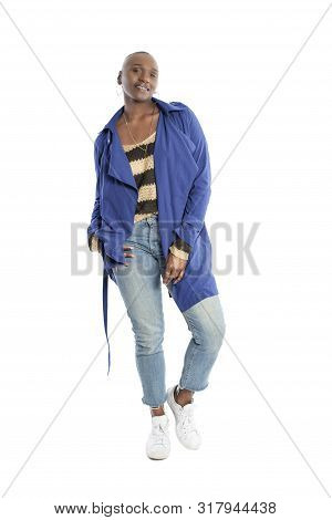Black African American Fashion Model With Bald Hairstyle Confidently Posing With A Vibrant Blue Colo