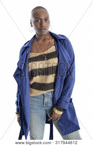 Black African American Fashion Model With Bald Hairstyle Confidently Posing With A Vibrant Blue Colo