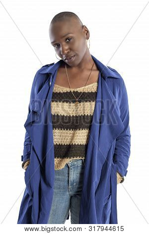 Black African American Fashion Model With Bald Hairstyle Confidently Posing With A Vibrant Blue Colo