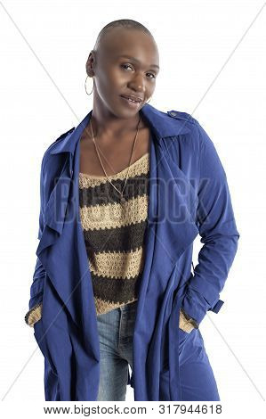 Black African American Fashion Model With Bald Hairstyle Confidently Posing With A Vibrant Blue Colo