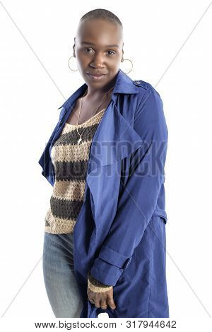 Black African American Fashion Model With Bald Hairstyle Confidently Posing With A Vibrant Blue Colo