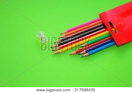 Drawings With Colored Pencils On A Green Background A Sharpener