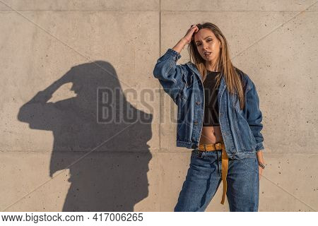 Half Body Photo Of A Pretty Young Woman Dressed In Jeans