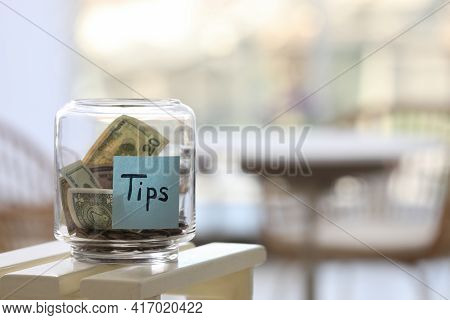Glass Jar With Tips On Table Indoors. Space For Text