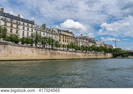 Tranquil Scene Of The Seine River With Haussmann Buildings In Paris