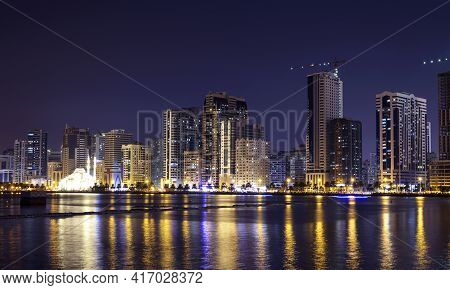 Sharjah,uae,dec 2nd 2020. Panoramic View Of The Illuminated Sky Scrappers Along With The Famous Al N