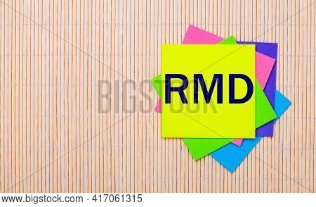 On A Light Wooden Background, Bright Multicolored Stickers With The Text Rmd Required Minimum Distri
