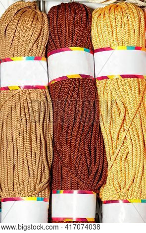 Rolls Of Polyester Cord In Various Colors Of Brown And Beige Shades, Rolled. Vertical Image, Close-u