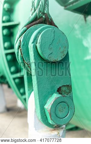 Close Up View Of Of An Old Green Steel Shackle With A Large Nut And Rusty Steel Cable