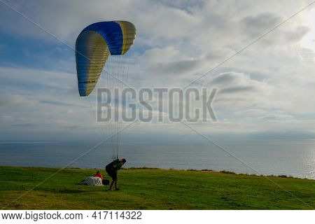 Man Doing Sport, Para-glider In The Clouded Sky. Paragliding Is An Extreme Sport And Recreation. Tor
