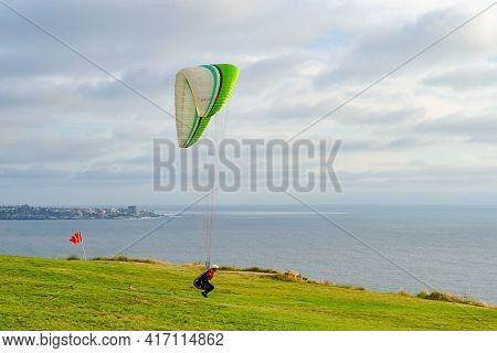 Man Doing Sport, Para-glider In The Clouded Sky. Paragliding Is An Extreme Sport And Recreation. Tor