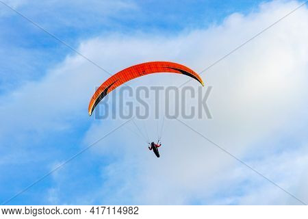 Man Doing Sport, Para-glider In The Clouded Sky. Paragliding Is An Extreme Sport And Recreation. Tor