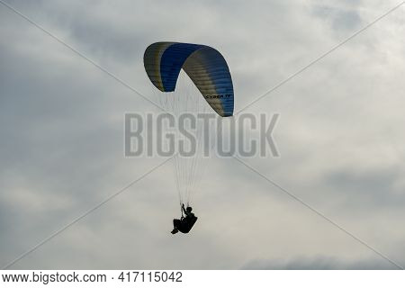Man Doing Sport, Para-glider In The Clouded Sky. Paragliding Is An Extreme Sport And Recreation. Tor