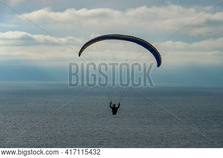 Man Doing Sport, Para-glider In The Clouded Sky. Paragliding Is An Extreme Sport And Recreation. Tor