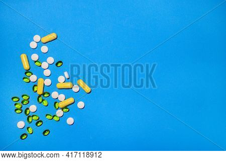 Vitamins And Capsules Of Different Shapes Were Scattered On The Table