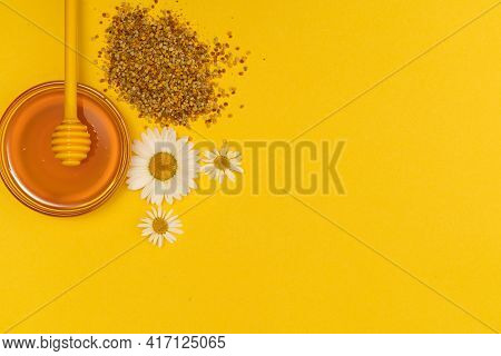 A Yellow Spoon Of Honey Dipped In A Jar Of Honey And Bee Bread Scattered On A Yellow Background Deco