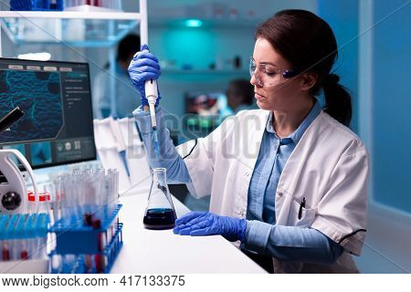 Scientist Taking Sample With Micropipette Wearing Glasses