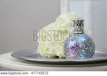 Stylish Catalytic Lamp With Hydrangea On Table In Room Closeup. Cozy Interior