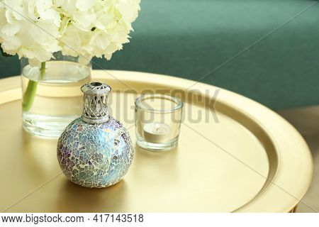 Stylish Catalytic Lamp With Burning Candle And Hydrangea On Golden Table In Living Room, Space For T