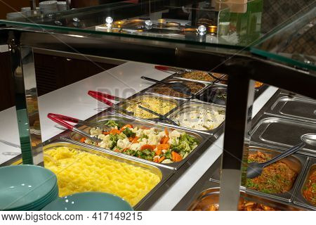 Side Dishes On The Serving Line, Self-service Restaurant. Steamed Vegetables, Rice, Buckwheat, Potat