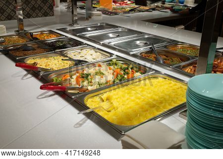 Side Dishes On The Serving Line, Self-service Restaurant. Steamed Vegetables, Rice, Buckwheat, Potat