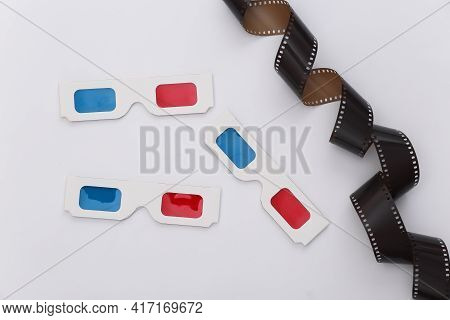Film Tape And 3d Glasses On White Background. Сinema, Entertainment Industry. Top View