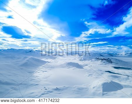 Spectacular Panoramic View Over Snowcapped Mountain Peaks, Ridges And Frozen Highland Tundra In Jotu