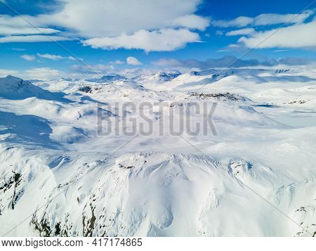 Spectacular Panoramic View Over Snowcapped Mountain Peaks, Ridges And Frozen Highland Tundra In Jotu