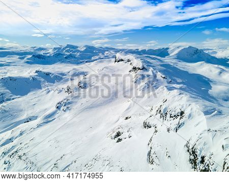 Spectacular Panoramic View Over Snowcapped Mountain Peaks, Ridges And Frozen Highland Tundra In Jotu