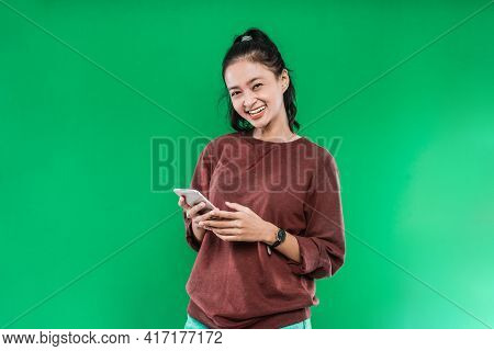 Portrait Beautiful Young Asian Girl Smiling Cute Holding A Phone While Looking At The Camera