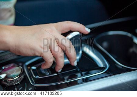 Hand Switches Modes On The Automatic Transmission Lever. Close-up. No Face. Driver Woman Hand Holdin