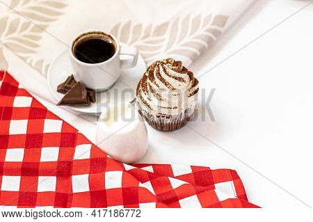 Dark Chocolate And Cocoa Chocolate Cupcakes With A Cup Of Hot Black Coffee On Red Napkin. Space For