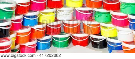 Screen Printing Ink In A Variety Of Bright Colors Is Laid Out In A Panoramic Semicircle And Stacked 