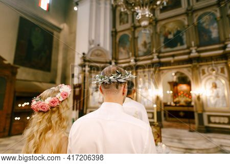 The Priest, The Groom And The Bride In Wreaths Stand At The Altar Of The Church Of St. Nicholas In K