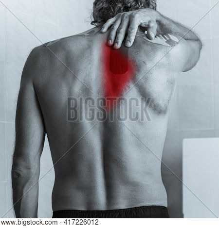 Black And White Photo Of Shirtless Sick Man Touching His Back